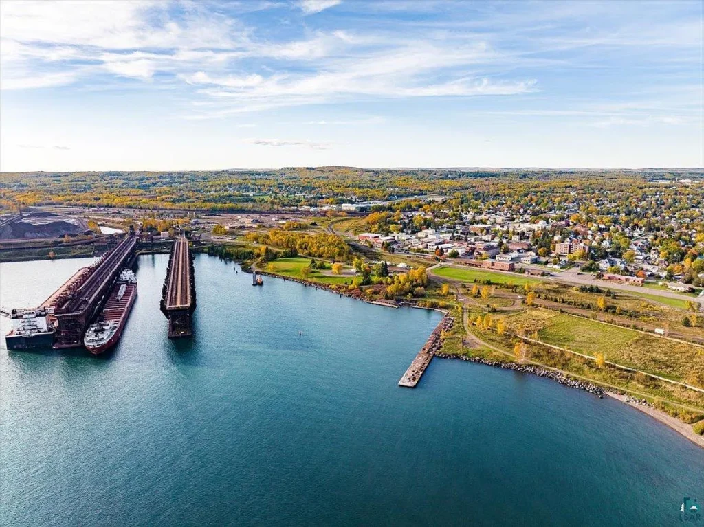 Two Harbors from the air in autumn, with an ore boat at the ore docks on Lake Superior